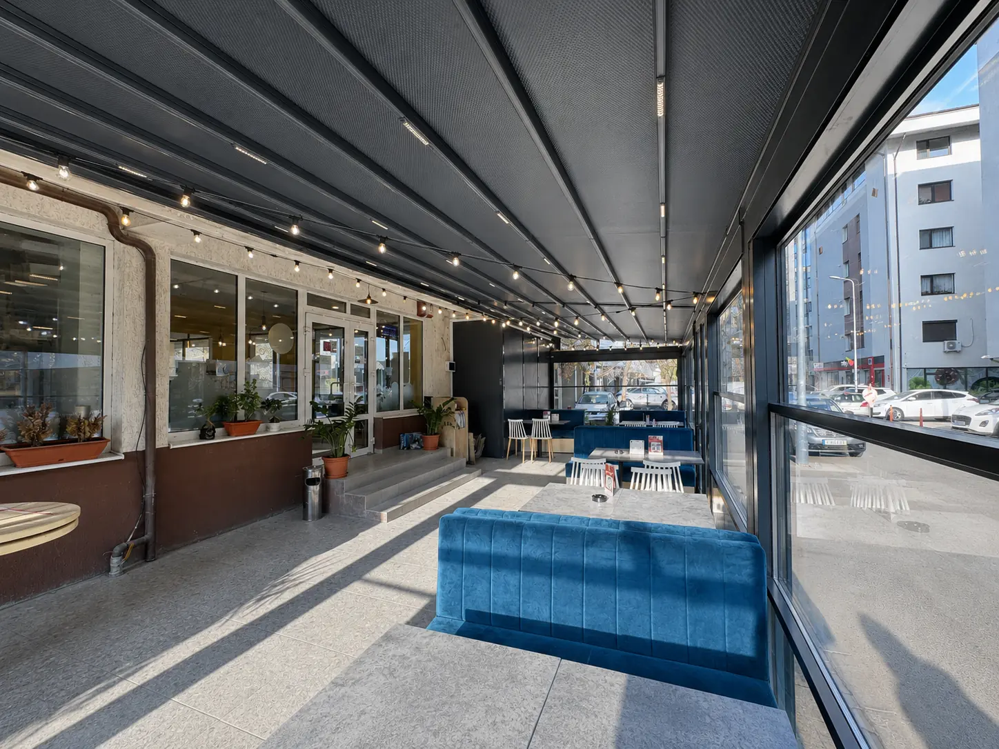 Interiorul pergolei retractabile cu membrană gri și iluminare LED integrată